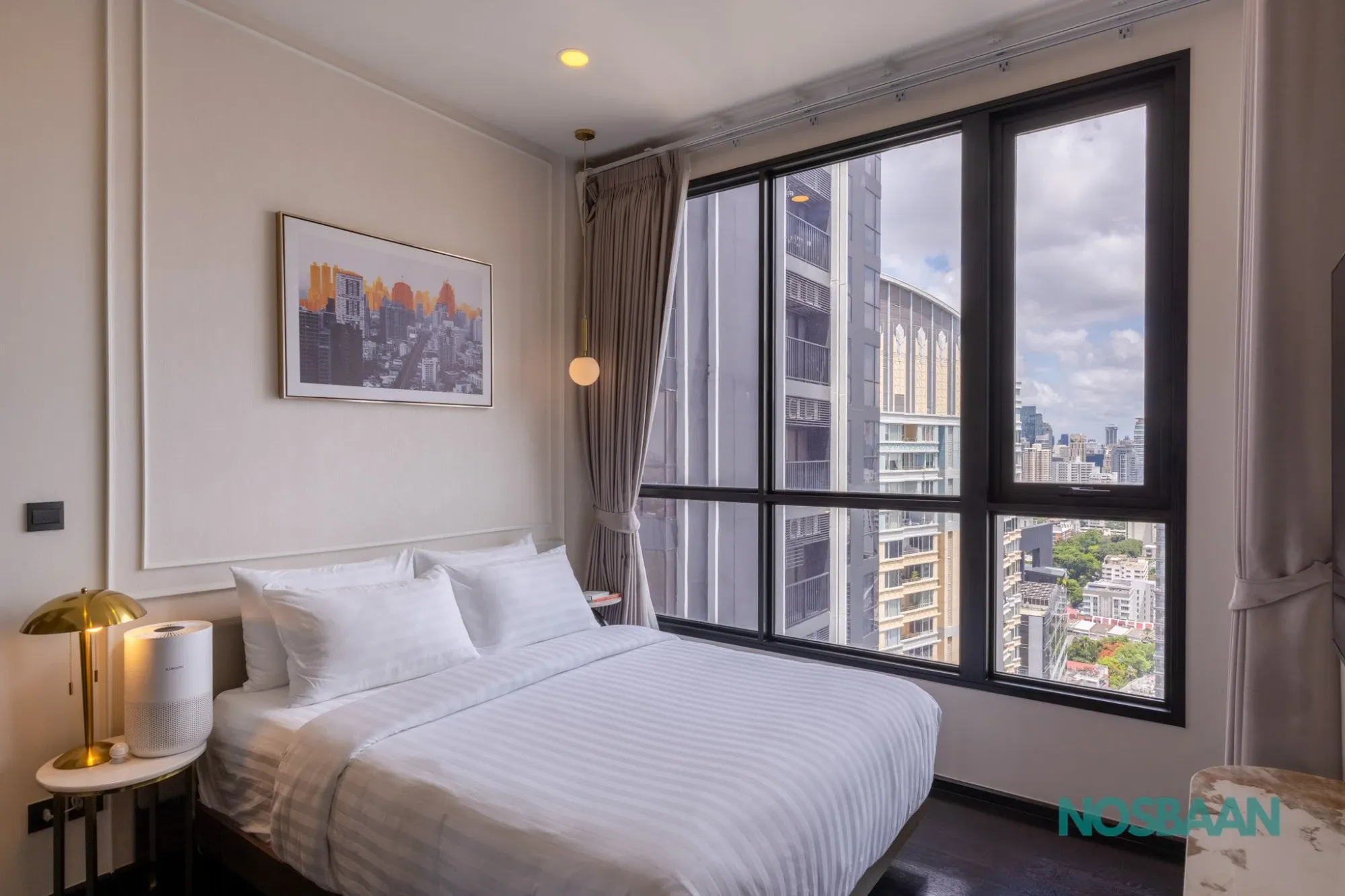 Bedroom with floor-to-ceiling city views at Park Origin Thonglor